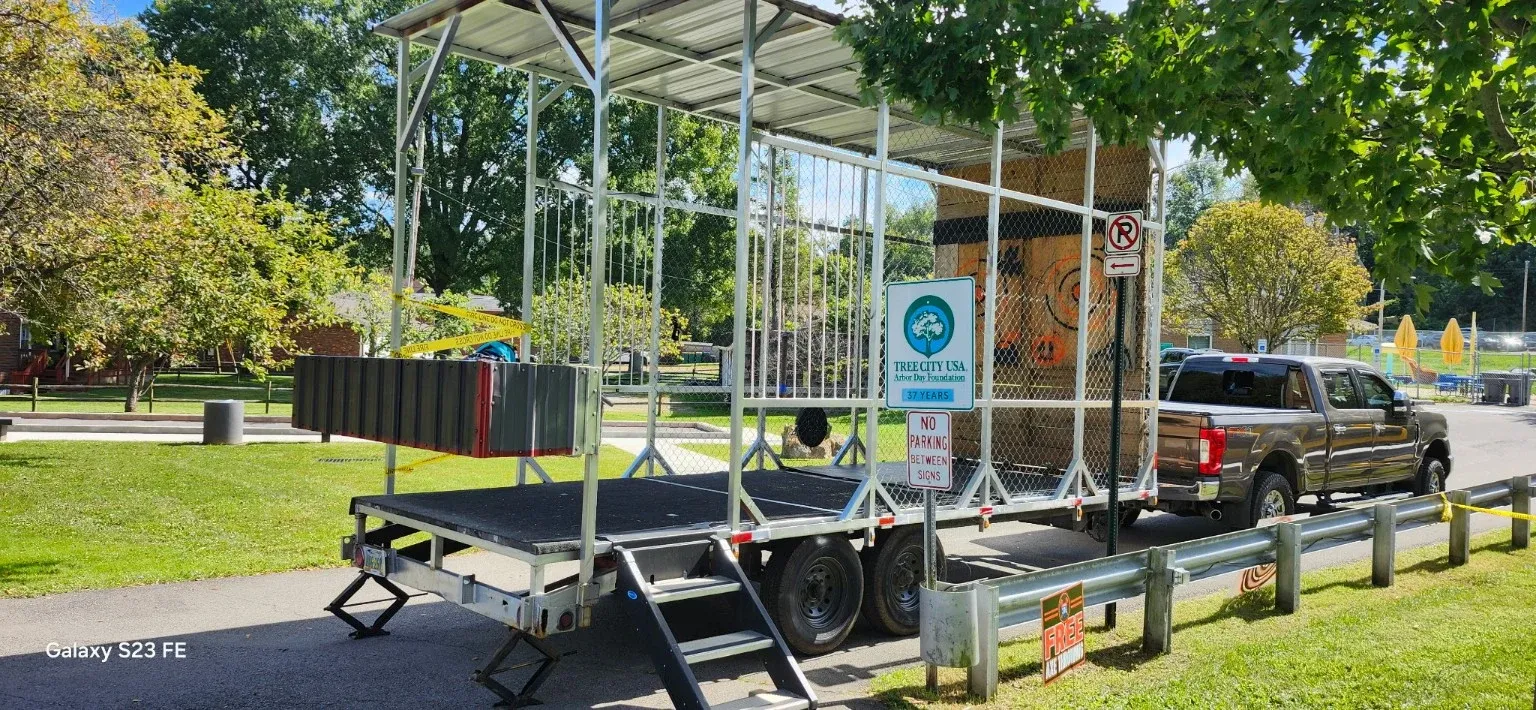 The 522 Axes silver trailer set up on the grass at a park event