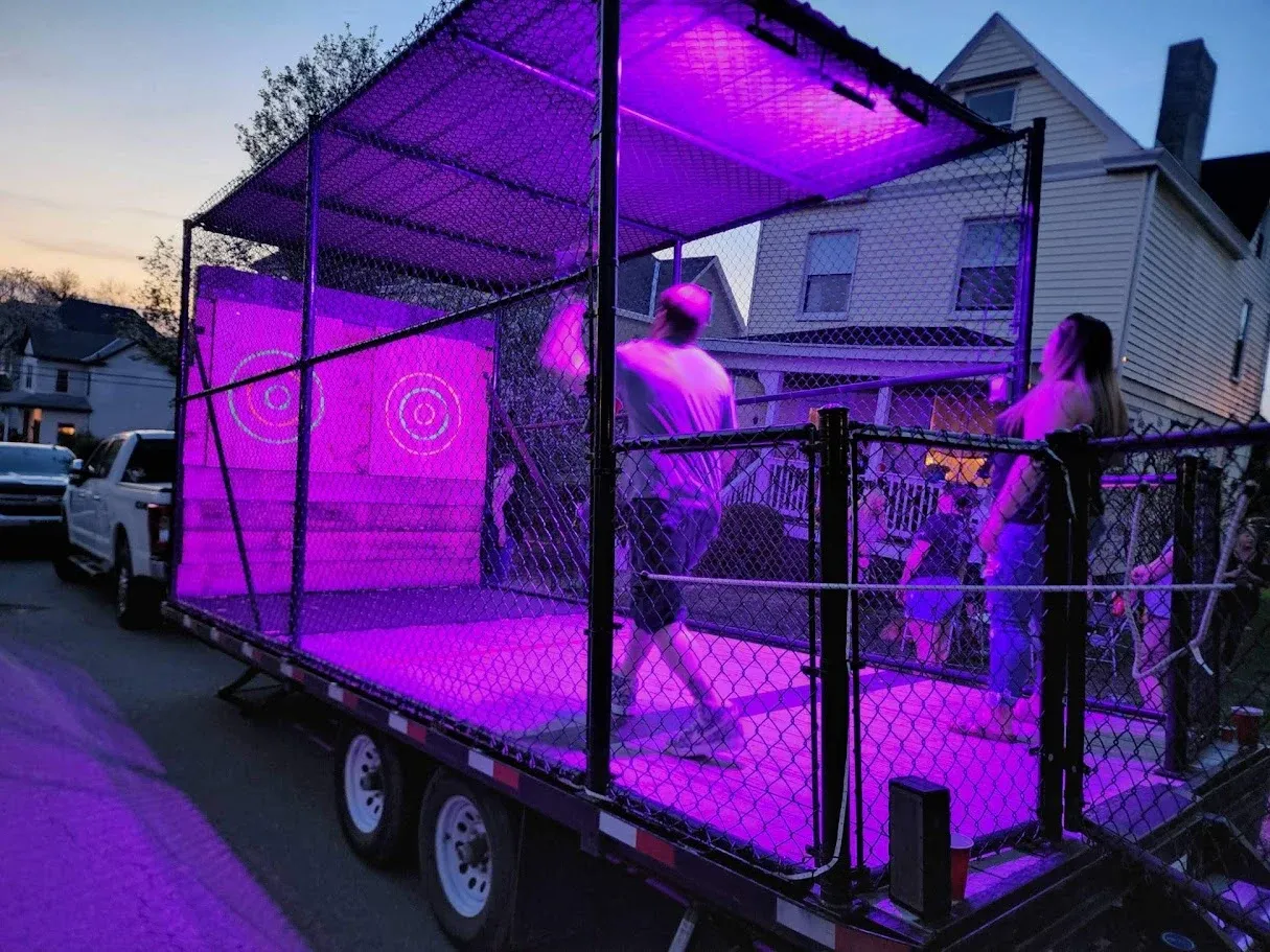 Guests throwing inside the trailer lit with purple glow lights